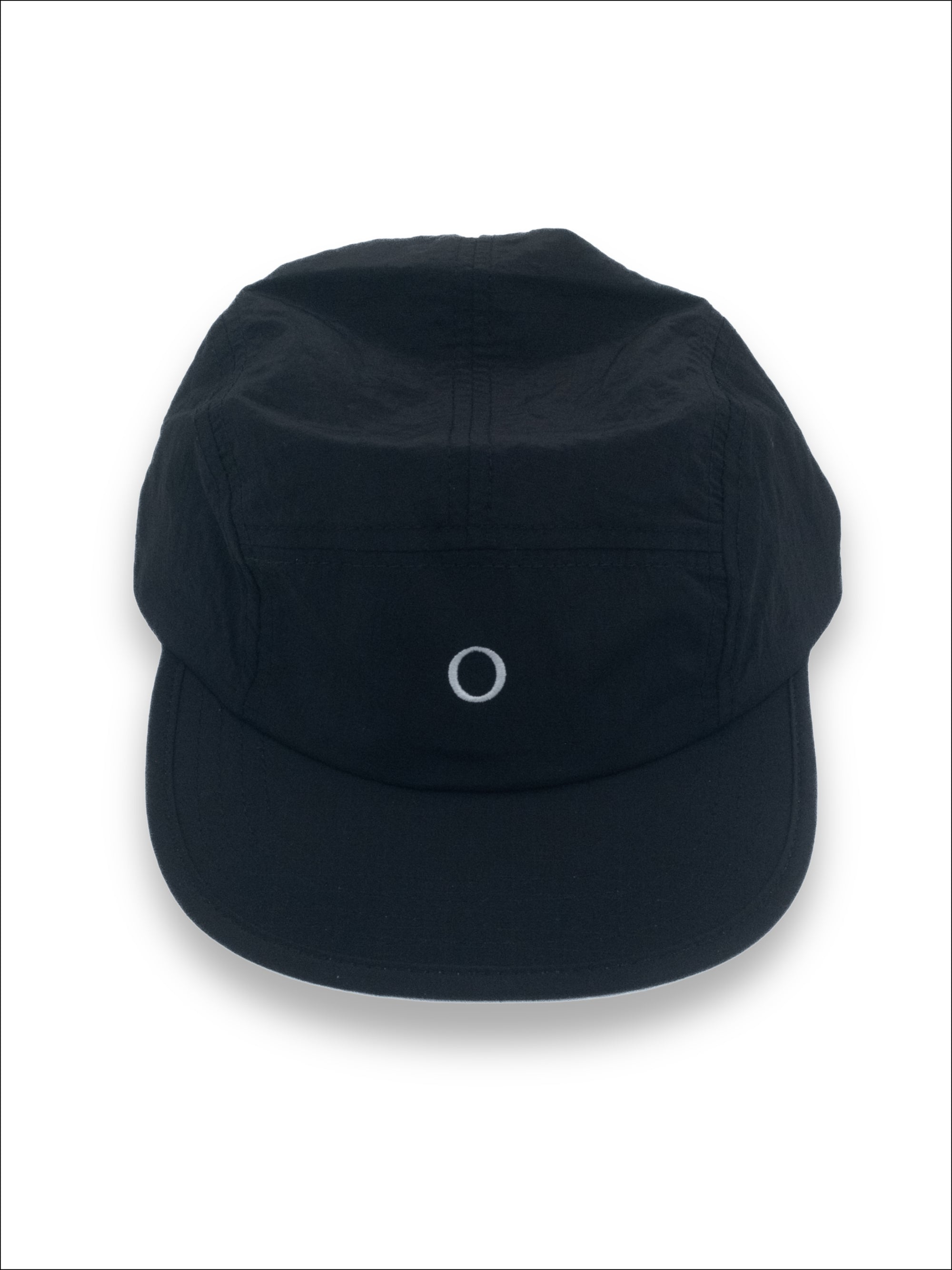 A black five-panel camp cap with a small white embroidered circle logo on the front, displayed against a clean white background.