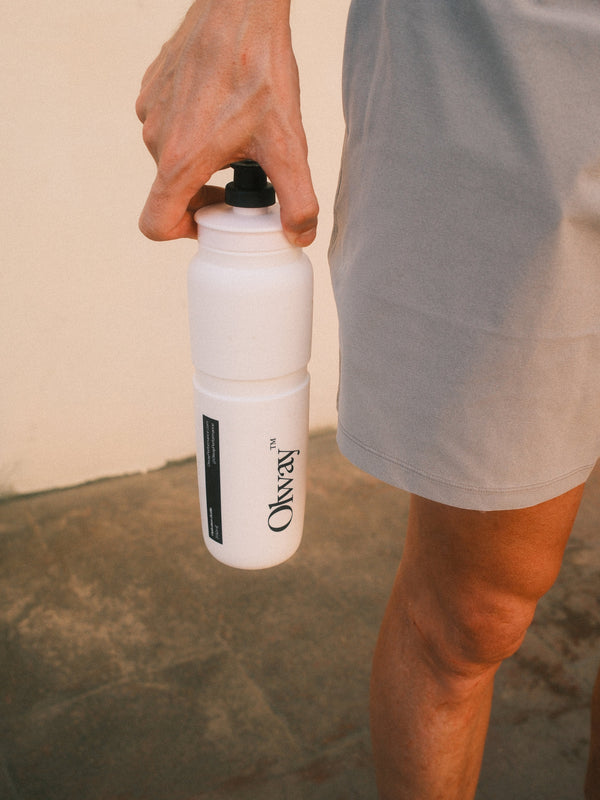 A runner carrying the Olway Hydration Bottle 950ml by its nozzle