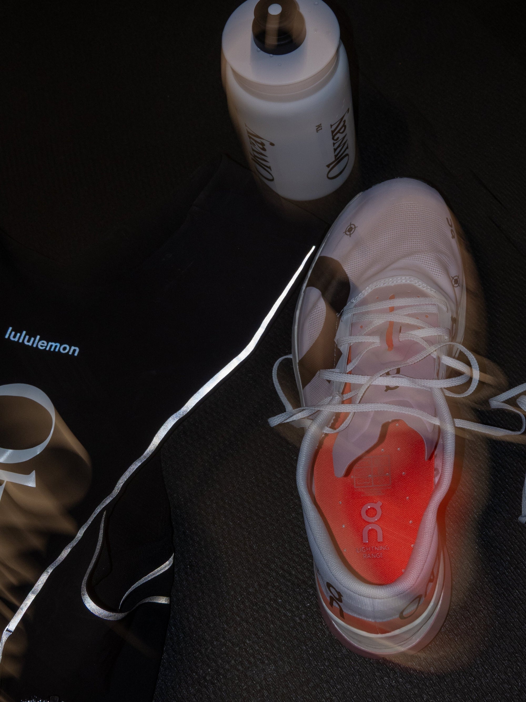 Olway Hydration Bottle 550ml beside running shoes and a kit bag