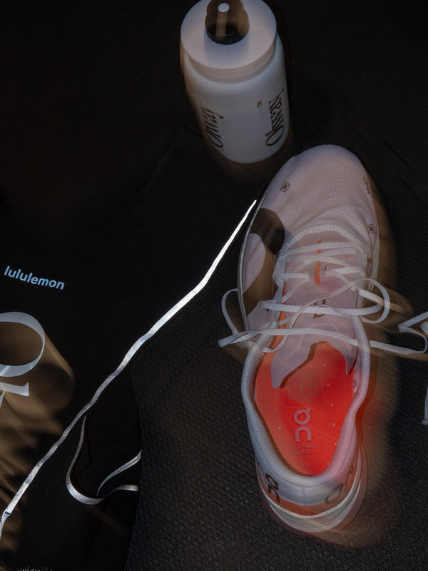 Olway Hydration Bottle 550ml beside running shoes and a kit bag