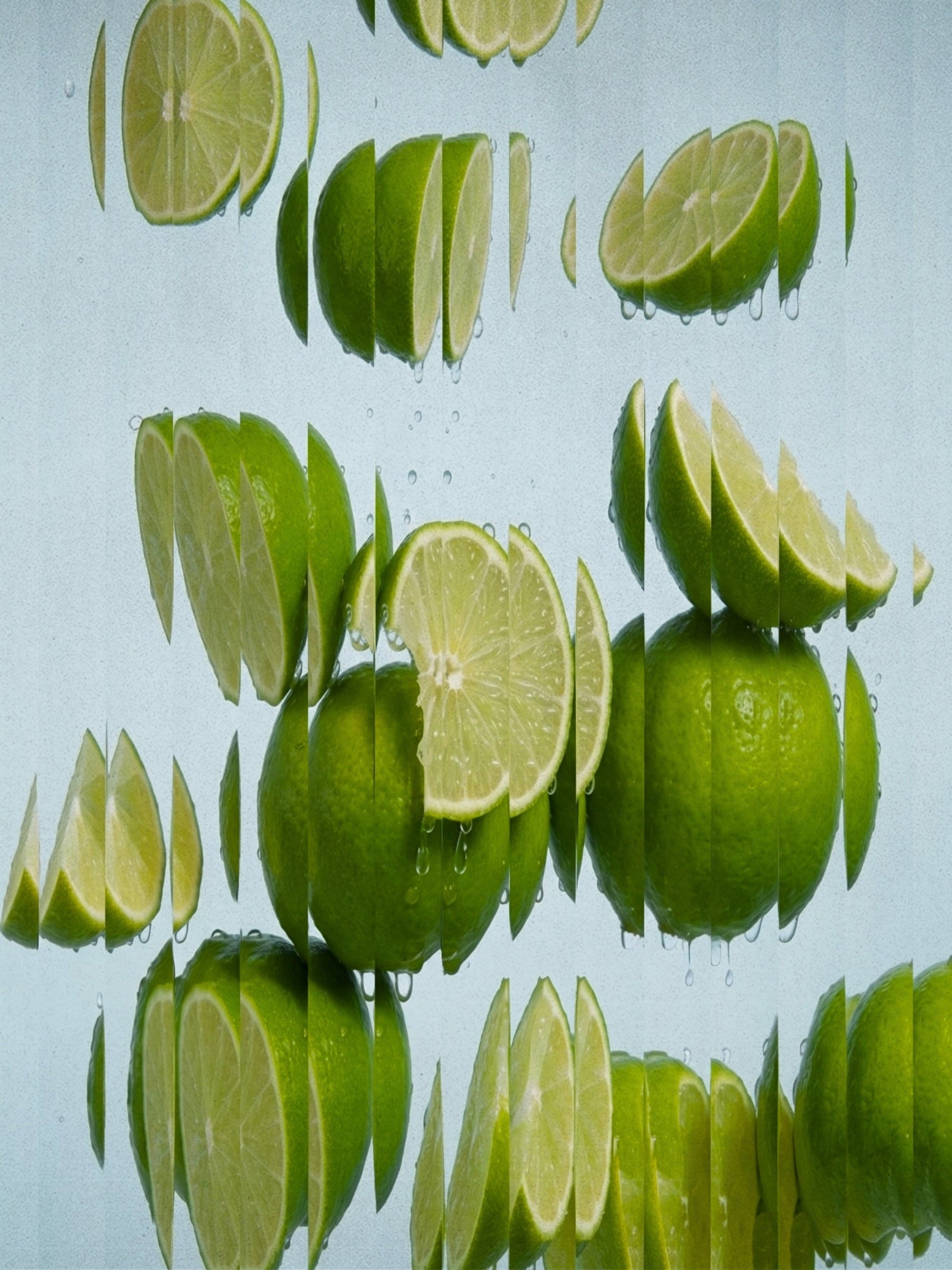 Fresh green limes, both whole and sliced, floating and reflected in clear water against a pale blue background. Lime Salt