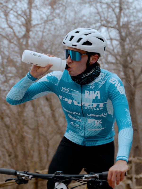 A cyclist drinking from an Olway Hydration Bottle 950ml