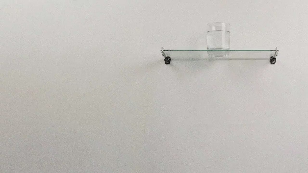 A glass of water on a glass shelf